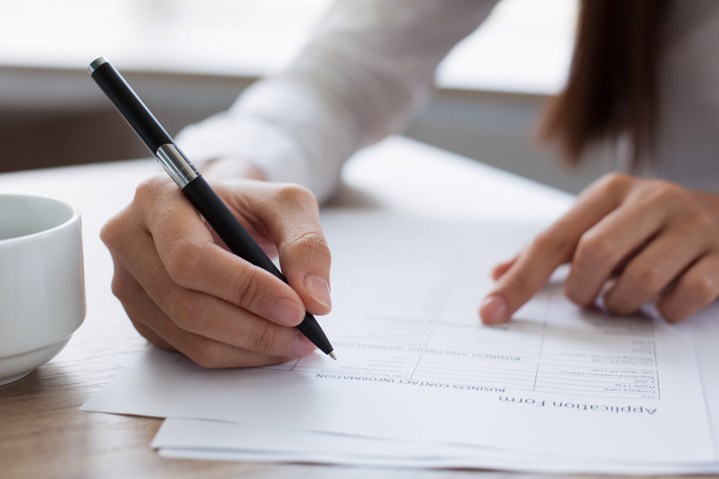 Closeup-of-Woman-Completing-Application-Form-636797270_3869x2579.jpeg