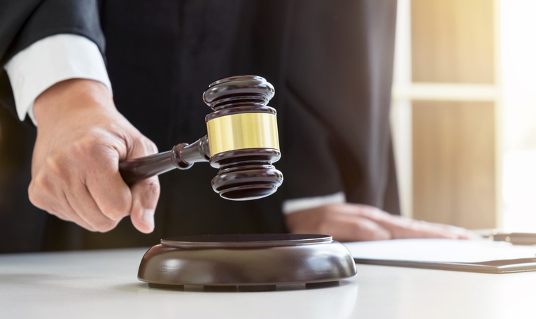 Close-up-of-Male-lawyer-or-judge-hand's-striking-the-gavel-on-sounding-block,-working-with-Law-books,-report-the-case-on-table-in-modern-office,-Law-and-justice-concept-928158772_770x458.jpeg
