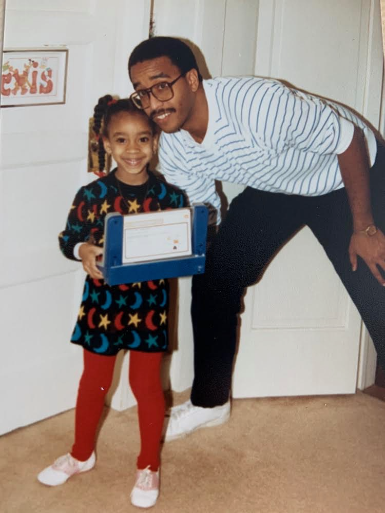 Alexis holding a toy with Her Dad Clyde