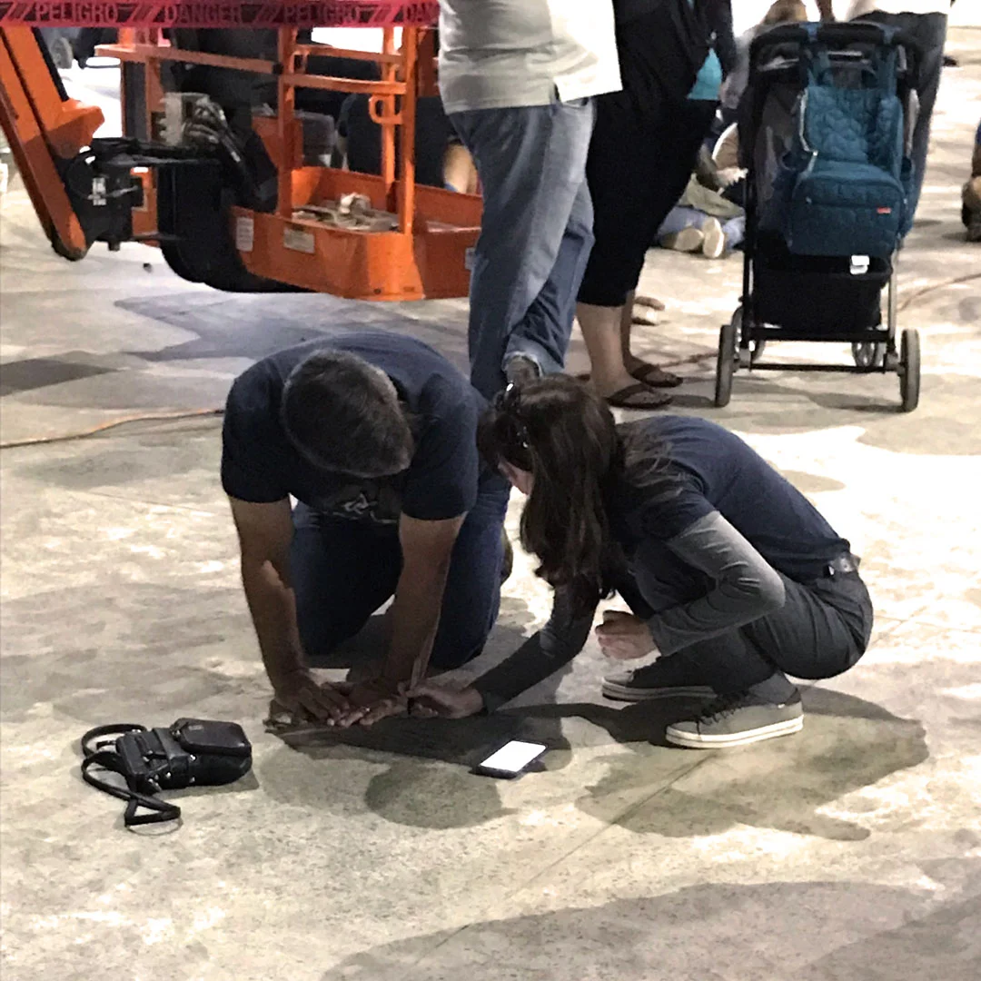 A Hope couple writes prayers and Scripture verses on the foundation of our new auditorium before construction is finished at an all-church prayer gathering.