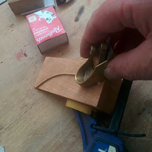 22. The rib is trimmed by holding a small plane against the bottom half of the mould 