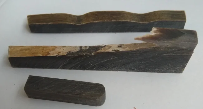 For the pillars the preferred material is buffalo horn. Hard wood can be used, but is more likely to split. Buffalo horn holds the pin firmly but is naturally greasy enough that the pillar will slide easily.