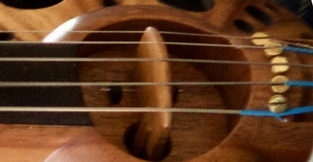 Note that both 1st string and 5th string have been hooked under the screw to increase string angle