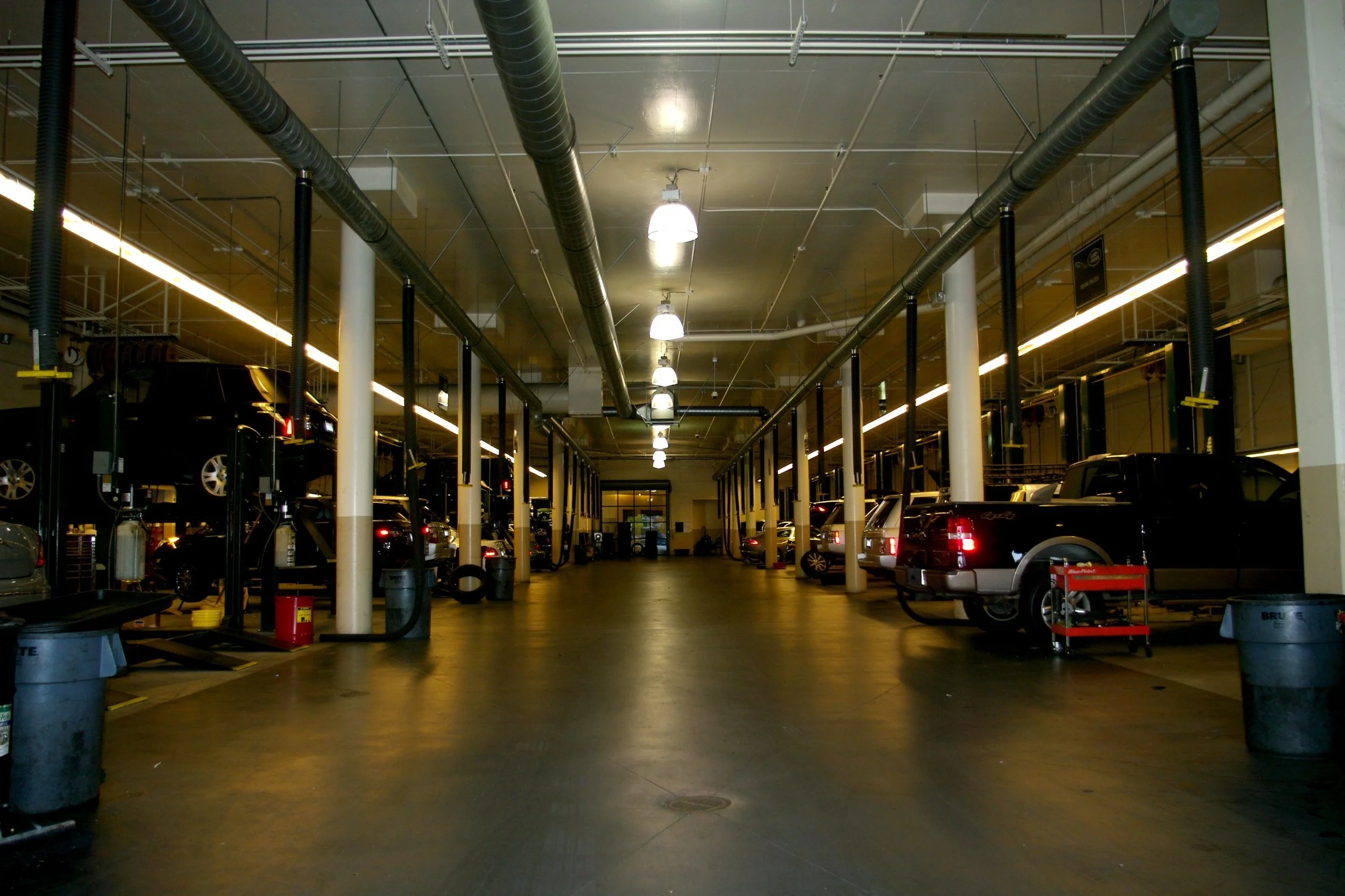 BEFORE – Lighting in car repair bays at dealer.
