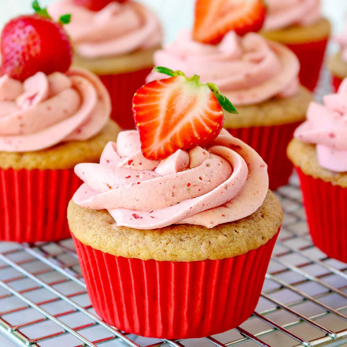 strawberry-cupcake-recipe-on-cooling-rack-with-strawberry-frosting-square.webp