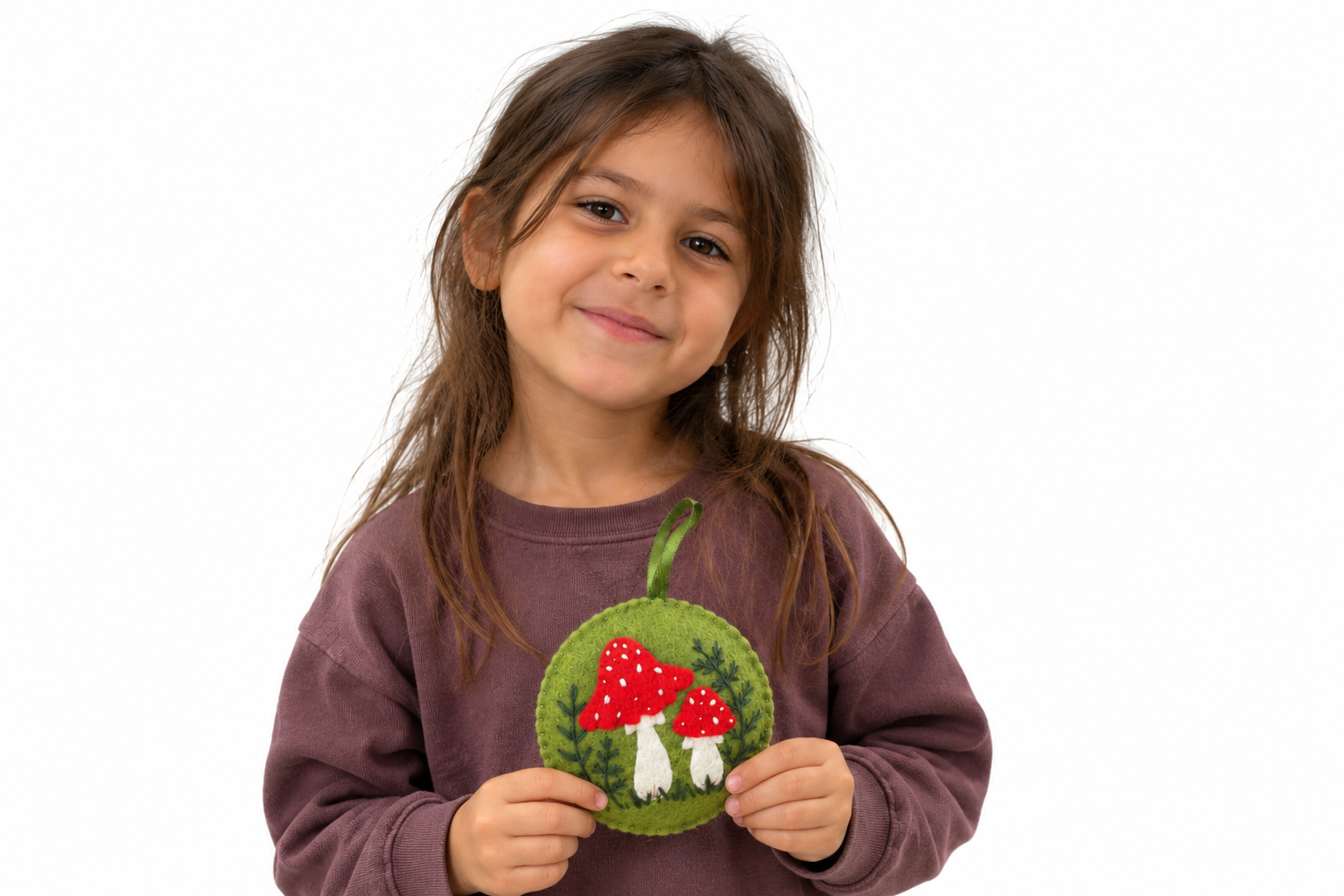 Girl Holding a Mushroom Felt Ornament.png
