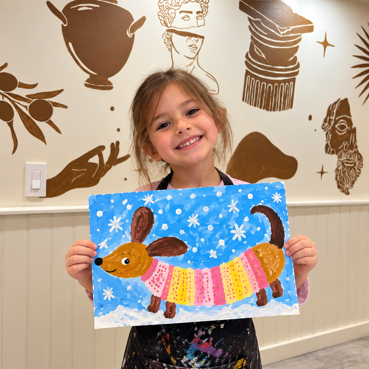 Proud Young Artist with Snowy Dog Painting.png
