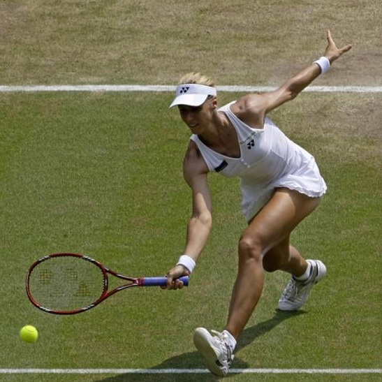 Elena Dementieva goes for the low forehand volley at Wimbledon.jpg