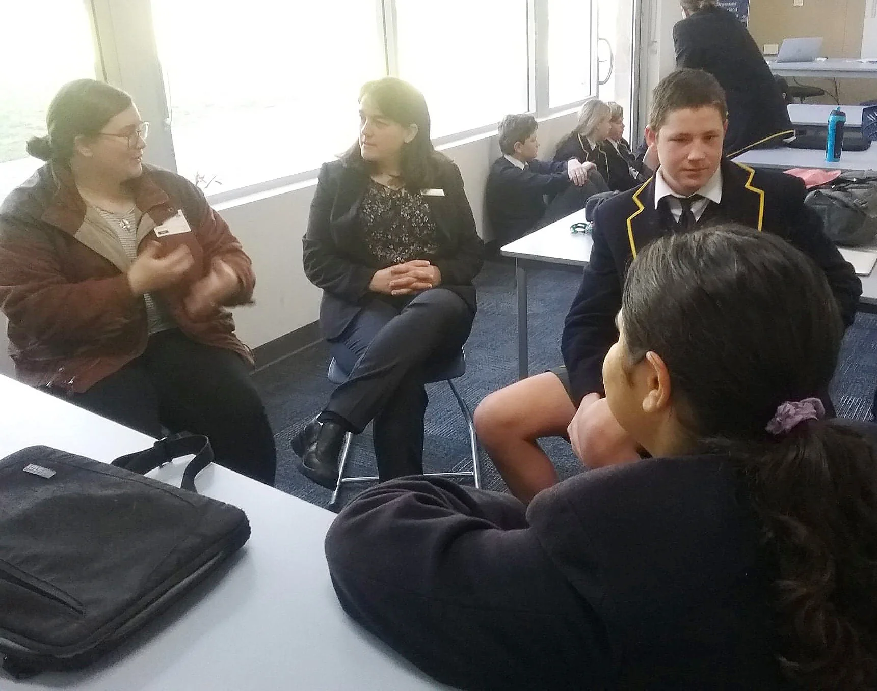 Maisie leads small group discussion with a class of year 9s
