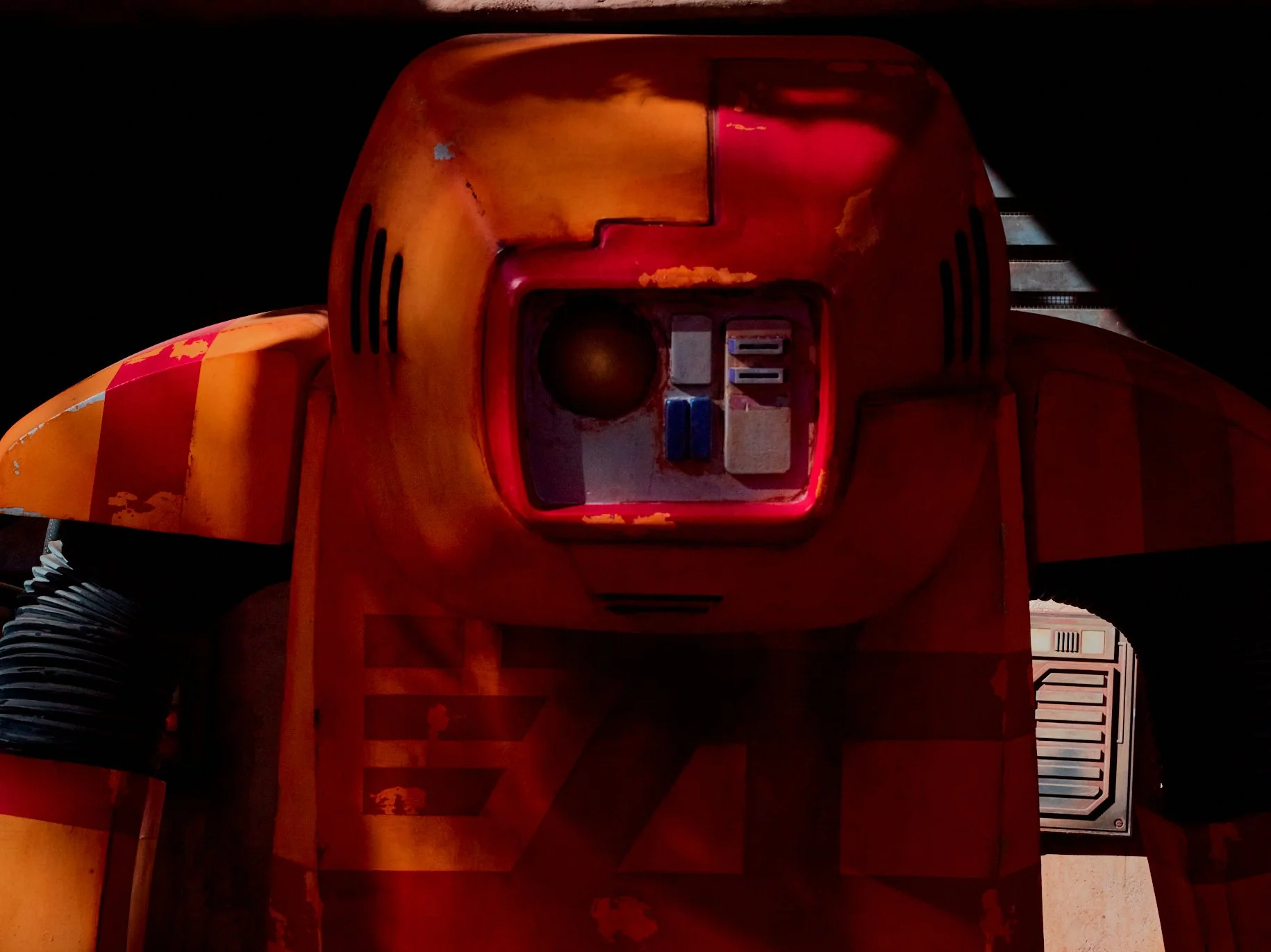 A Droid is standing in your way! The door in the background is sharp and clear. The droid is so close that it’s a bit intimidating when it asks for your password. It’s red, orange, with one glowing eye and speckled with light, giving it a tough look.