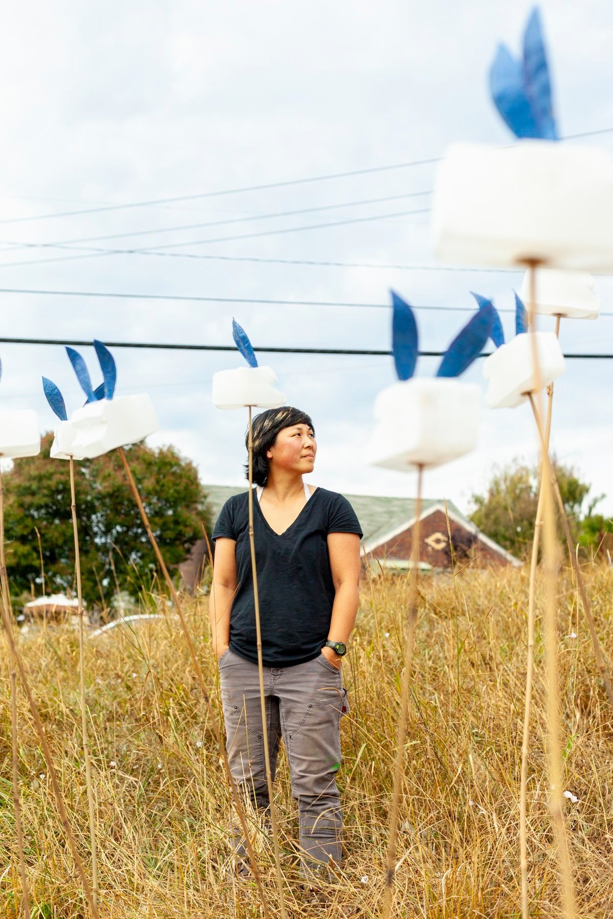 Artist JoEllen Wang standing in her public art installation "Camper Fluffle", Seattle WA