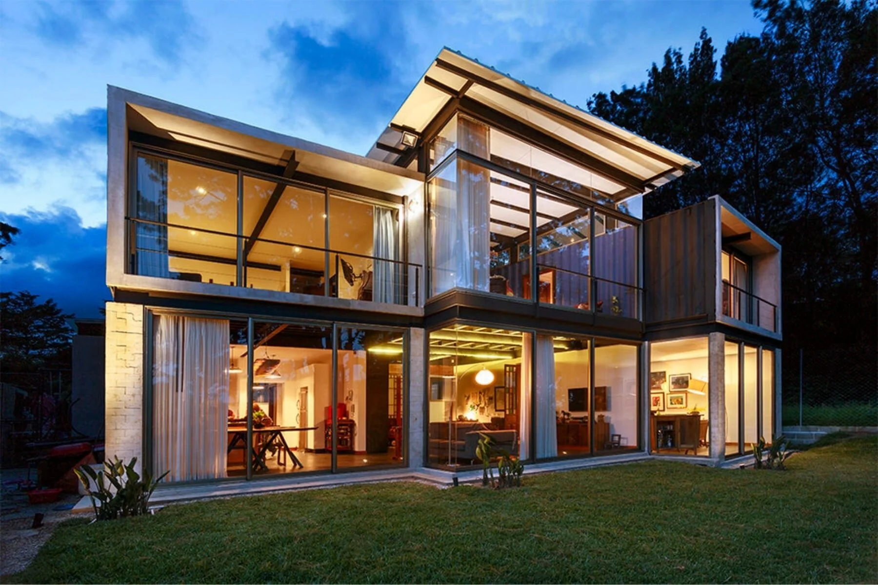 Guatemala Home shipping container house by Olivero Bland Studio at dusk