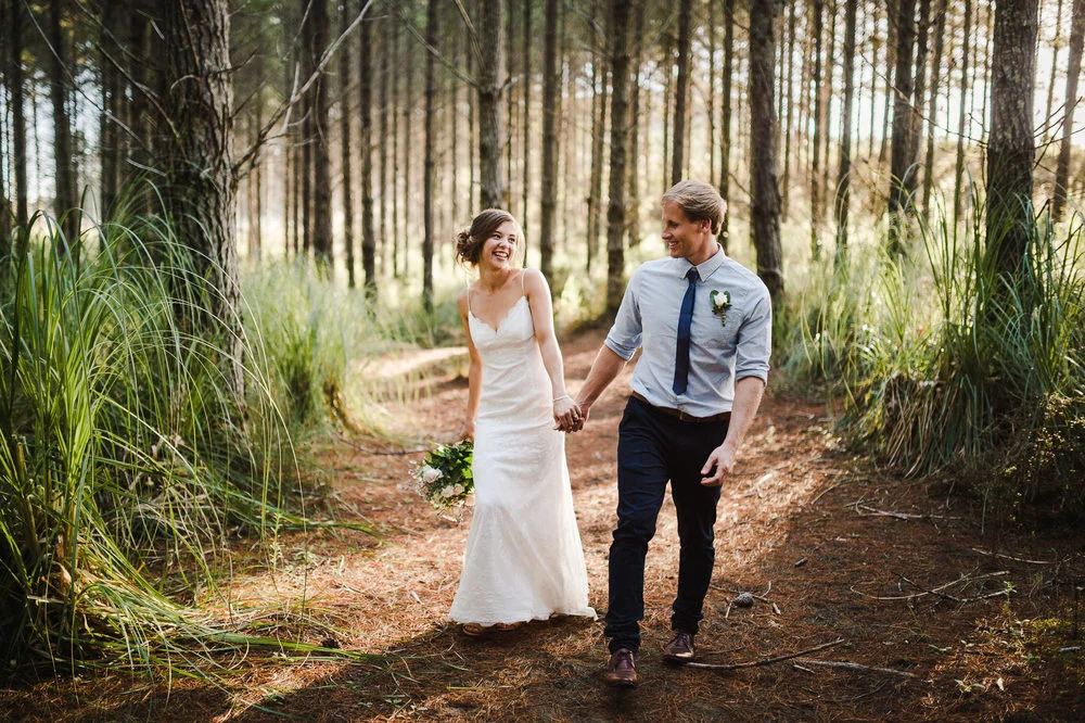 bride+and+groom+walking+through+forest+auckland+wedding.jpg