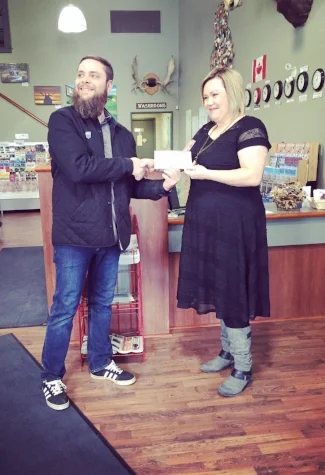 Chad Klyne accepting the top prize from Jacki L'Heureux