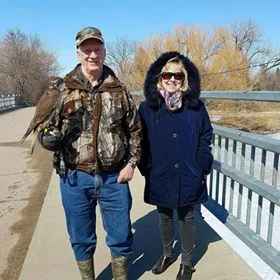 Larry and his wife Norma with Puff the Prairie Falcon at Wakamow.