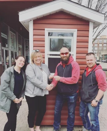 Kaitlyn Aparicio and Jacki L'Heureux-Mason with Wendell Gillert and Nick Pettigrew, from Home Building Centre (who donated the building)