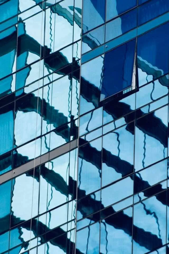 The reflection of the sky can clearly be seen in windows on high rise buildings such as this, confusing birds into flying right into them (photo source unknown), killing thousands yearly.