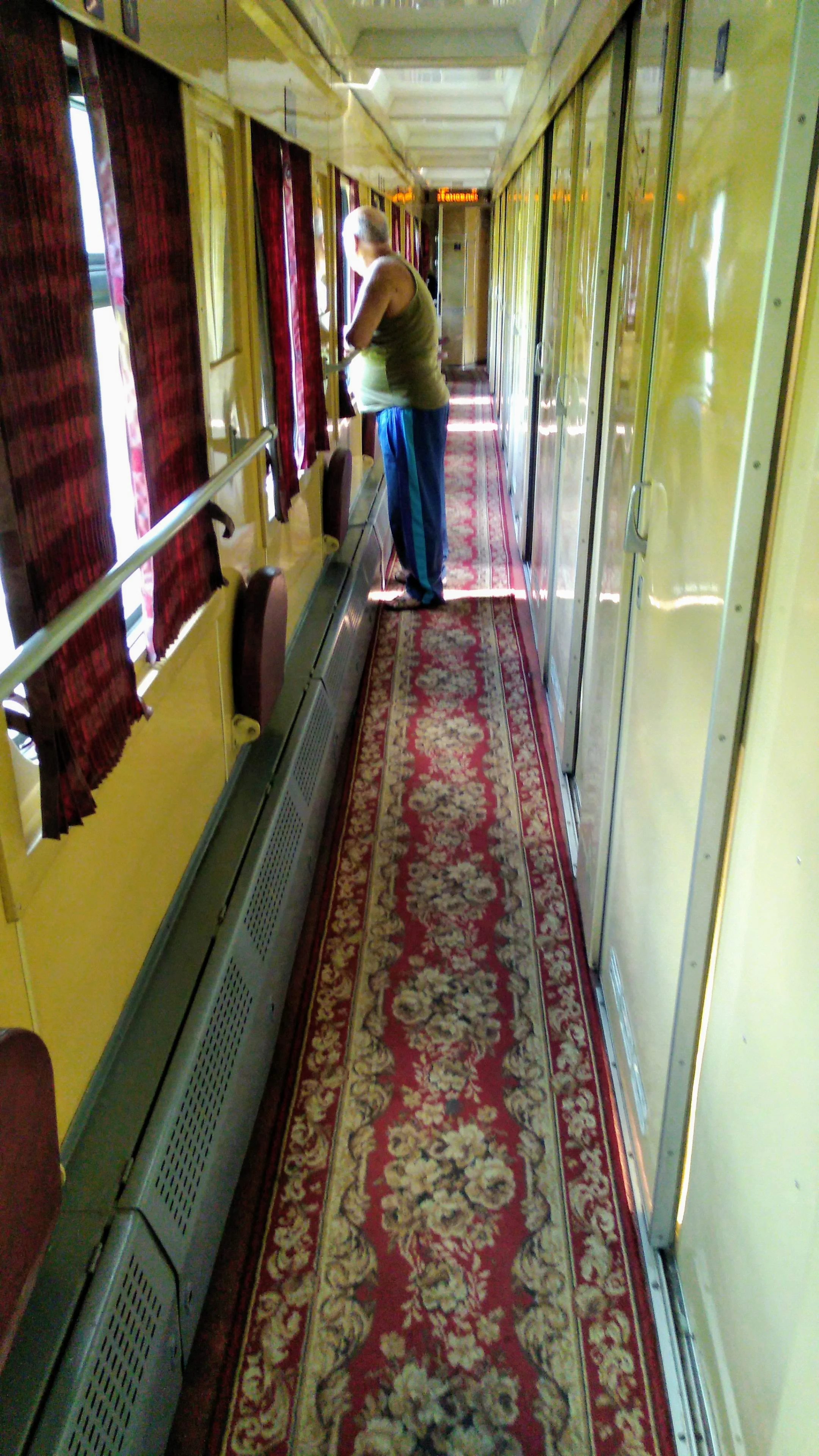 The corridor in the train adjacent the cabins