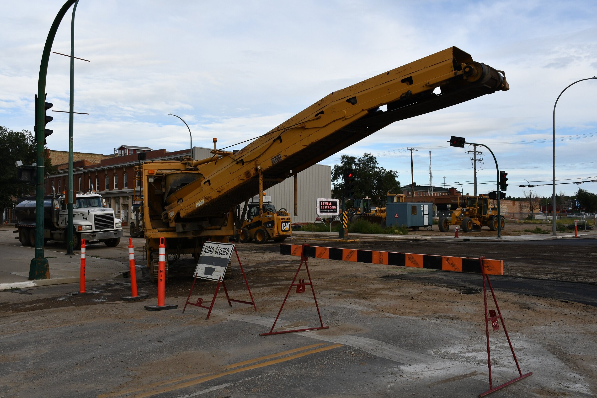 Asphalt milling machine sits at the intersection of High Street West and 1st Avenue NW - MJ Independent photo