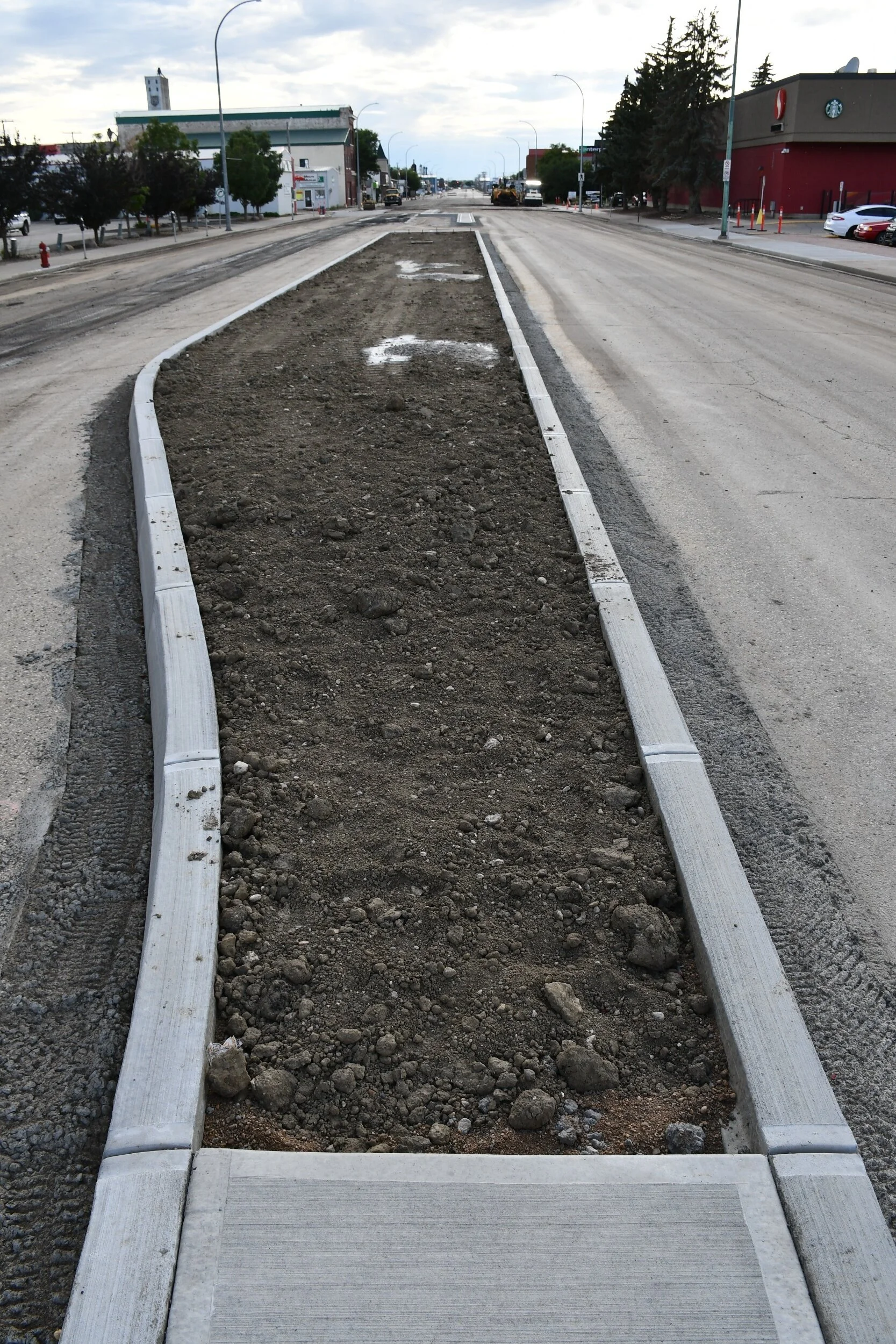 The plantable median on the 100 Block of High Street West is now filled with soil - MJ Independent photo