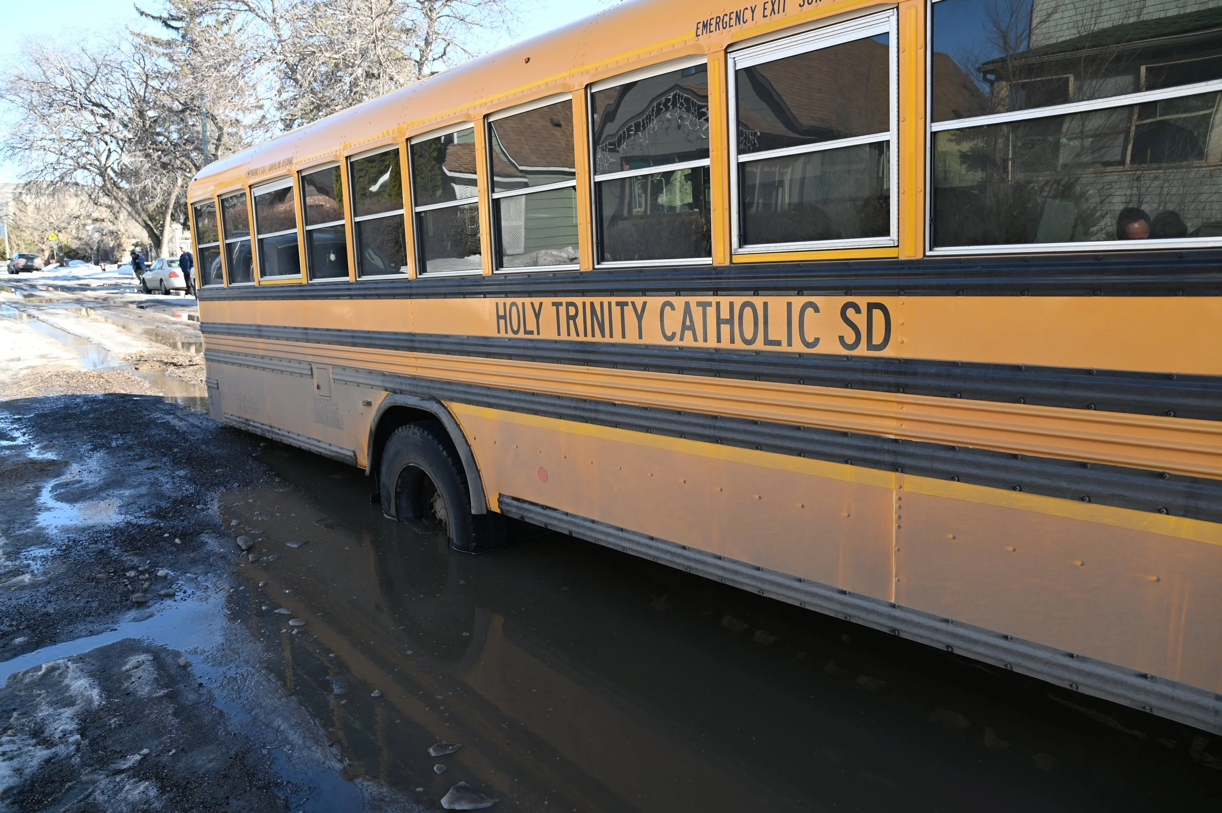 School Bus Drops Into Soft Spot Requiring A Tow Truck