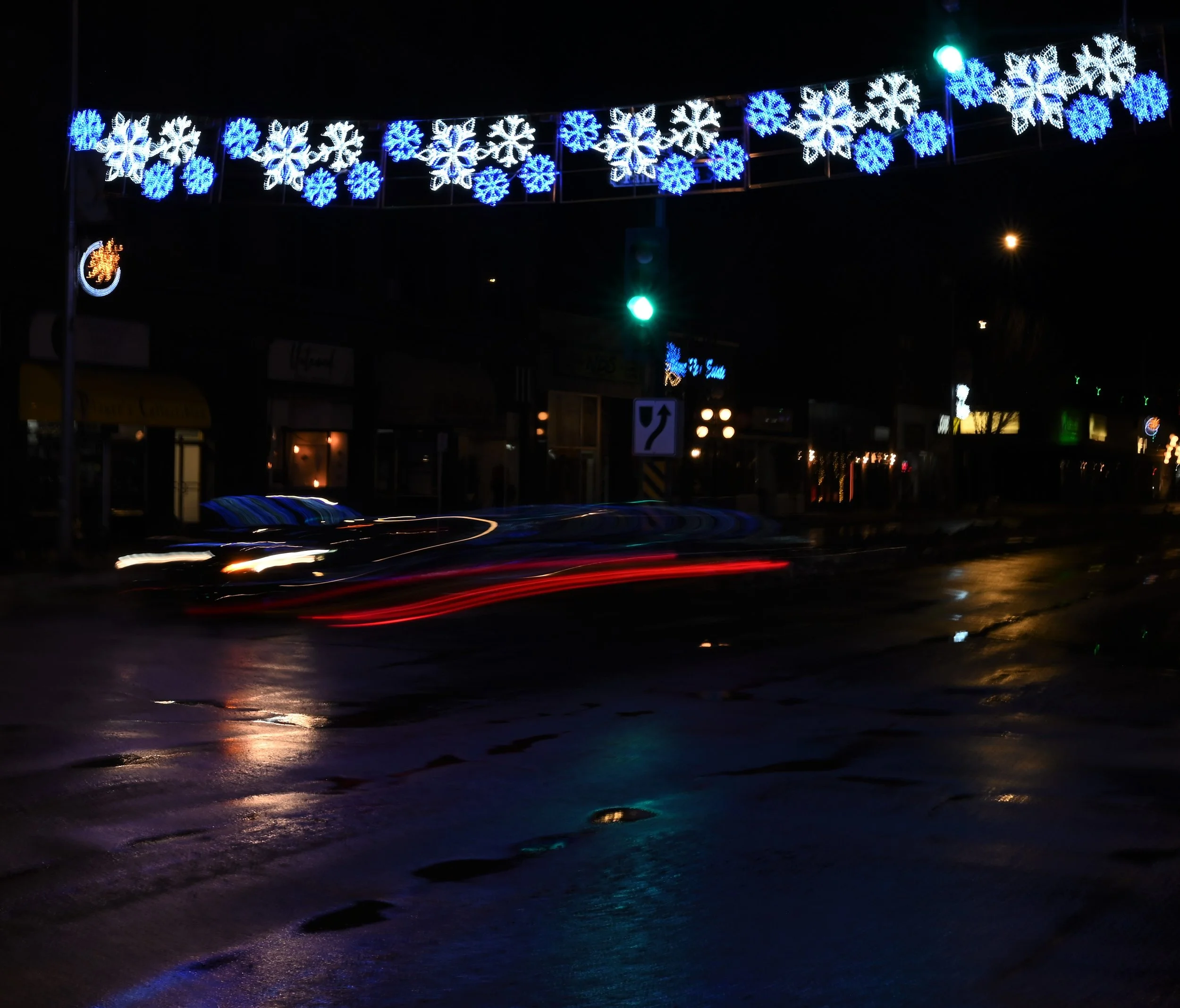 Christmas Lights Shine Off Of Wet Pavement