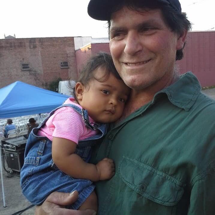 The author’s father holding his granddaughter.