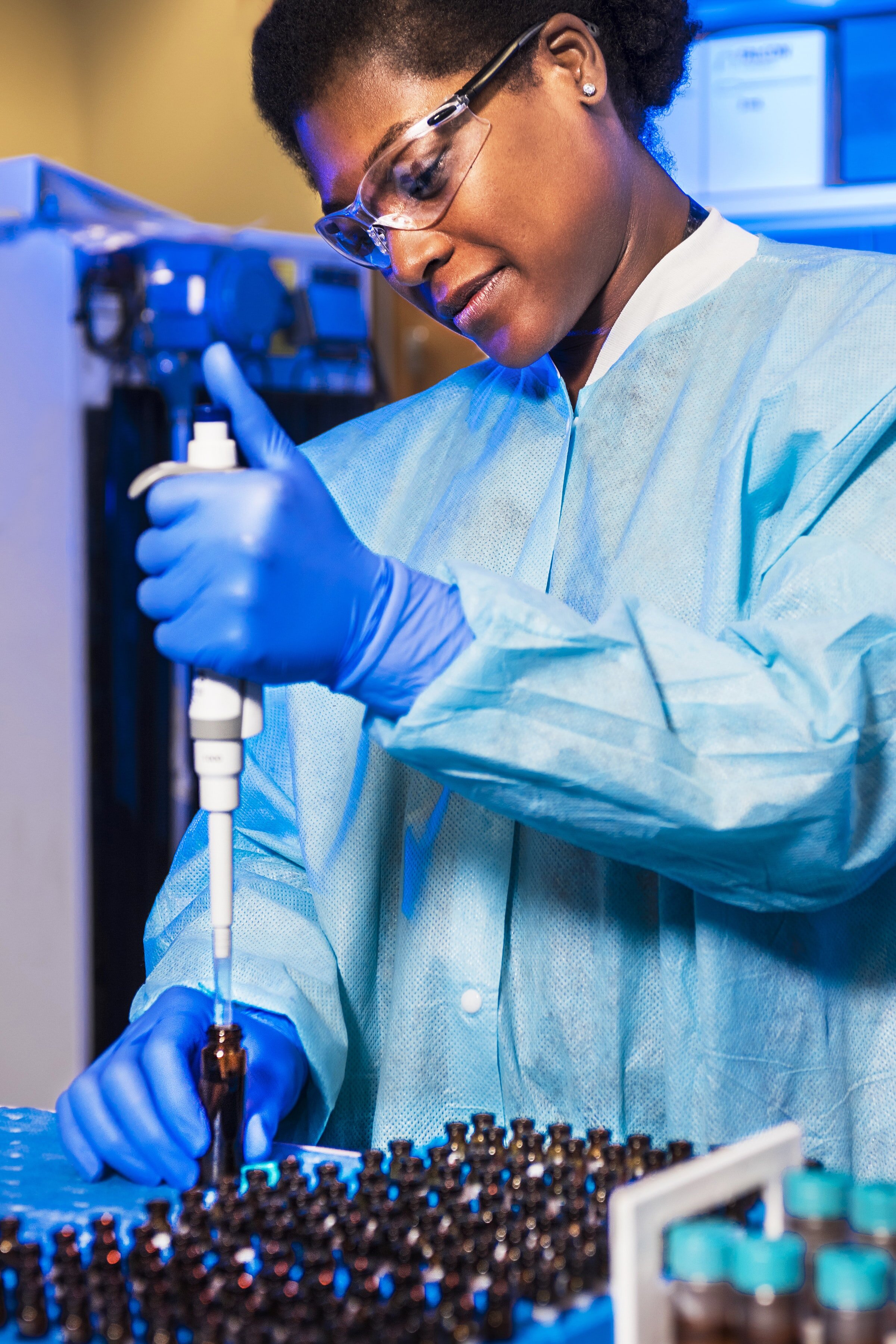 Photo of a researcher using a research device on a brown bottle by CDC on Unsplash.