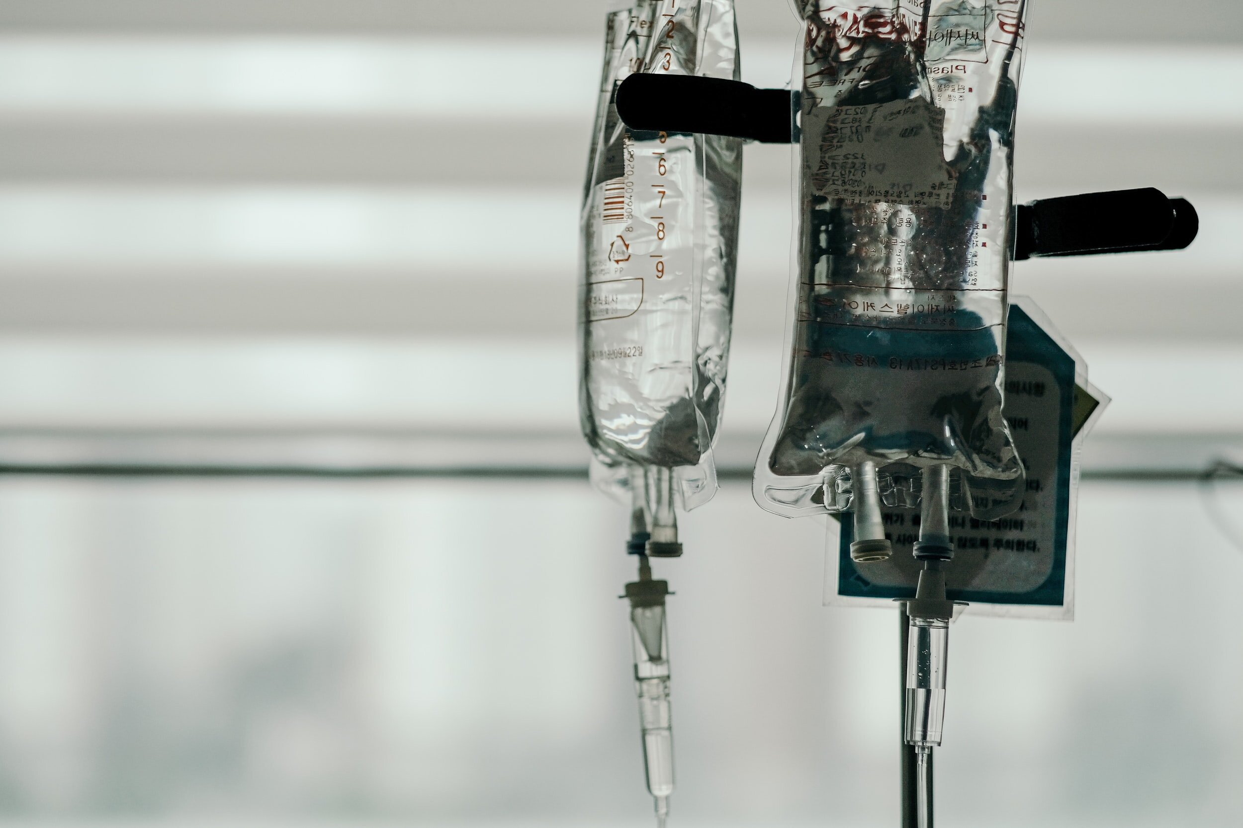 Photo of clear fluid in an IV bag hanging by Insung Yoon on Unsplash