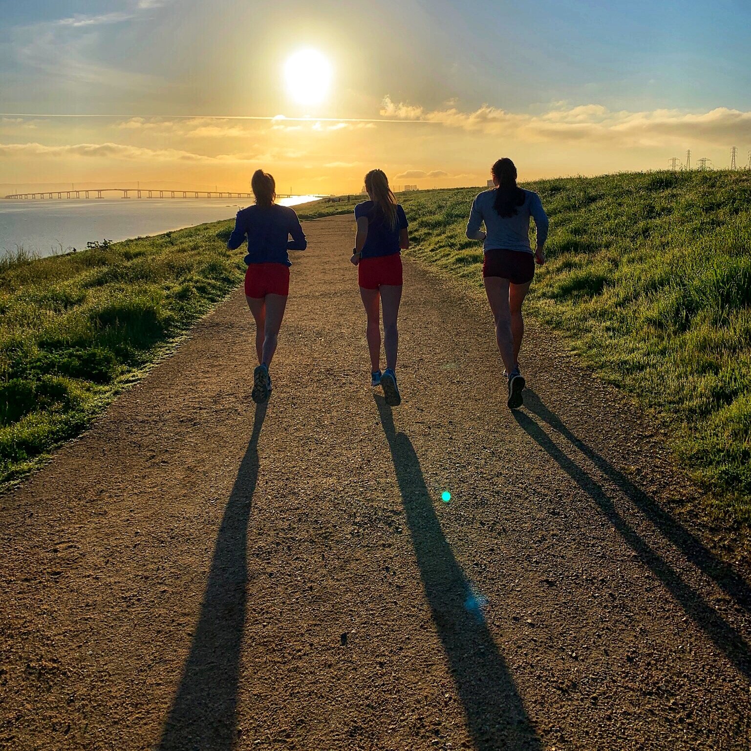 Image of the blog author and two other women running on a dirt path in the sun.