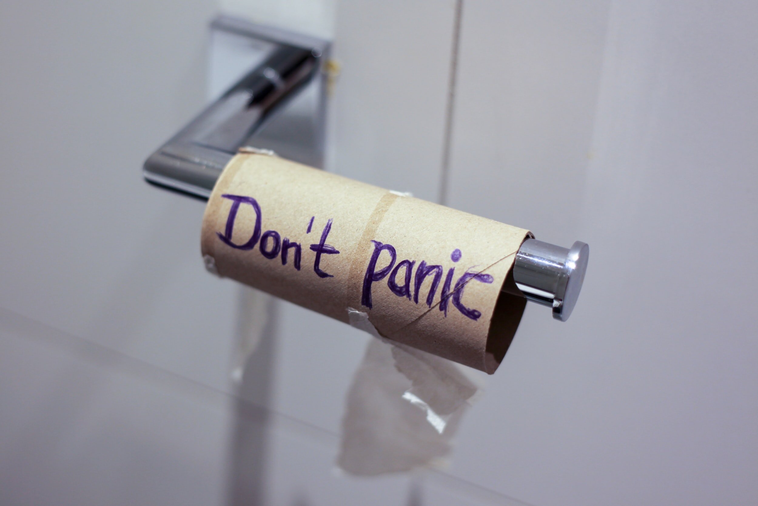 Photo by Jasmin Sessler on UnsplashPicture of an empty toilet paper roll saying “don’t panic.” Easier said than done!
