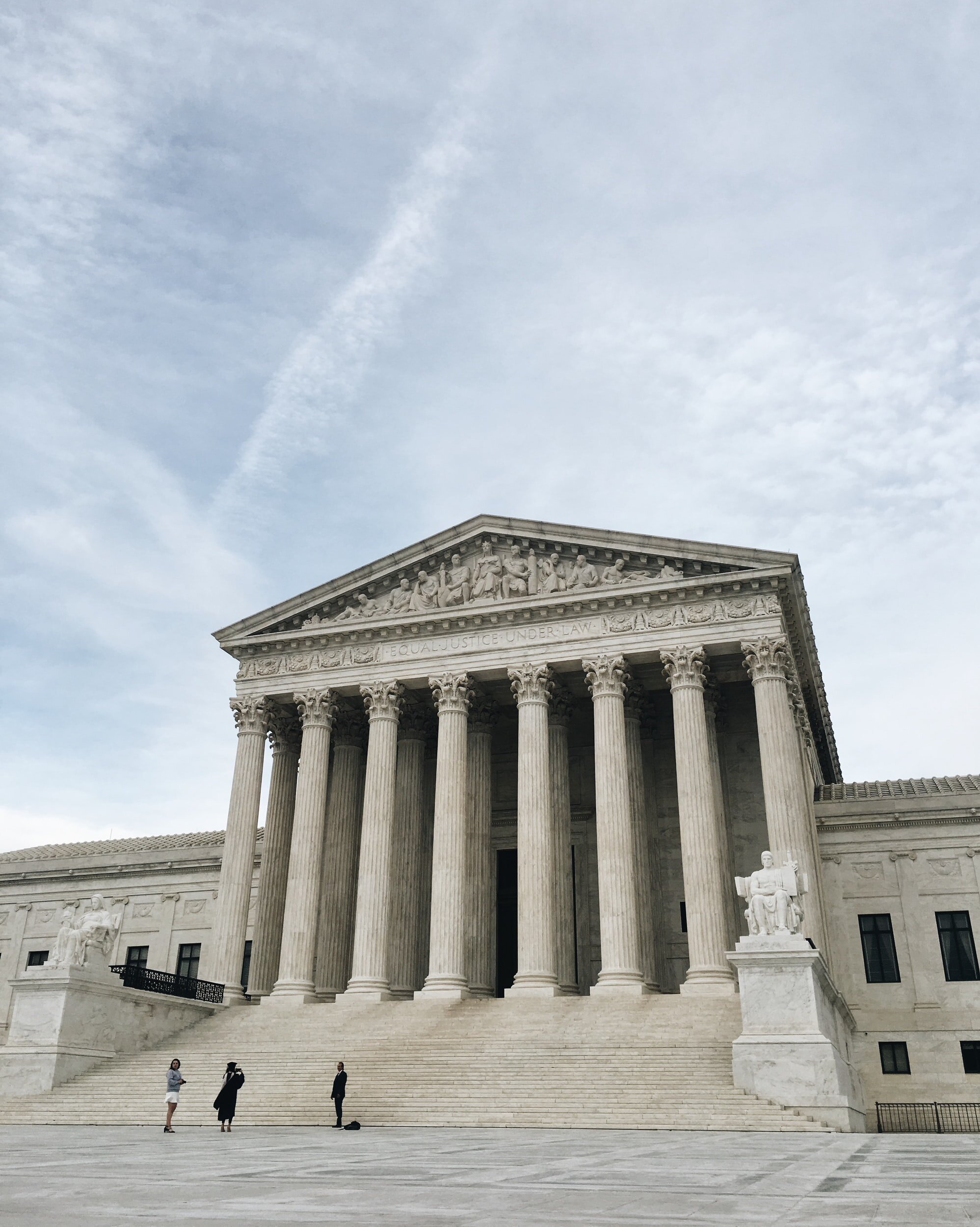 Photo by Anna Sullivan on UnsplashPhoto of the front of the Supreme Court Building on a cloudy day.