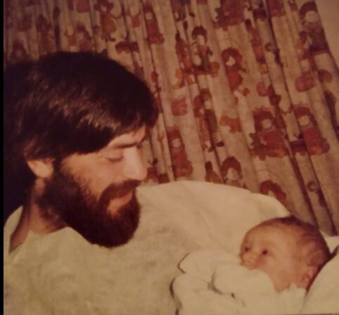 An image of the blog author as a baby being held by her dad who is seated.