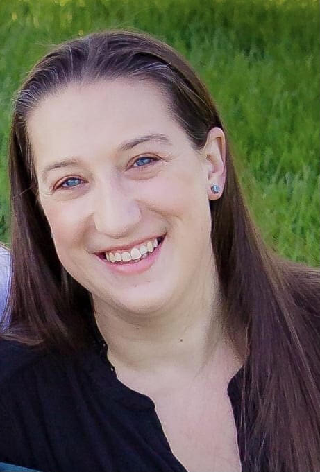 Image of the blog author, a woman with long brown hair smiling.