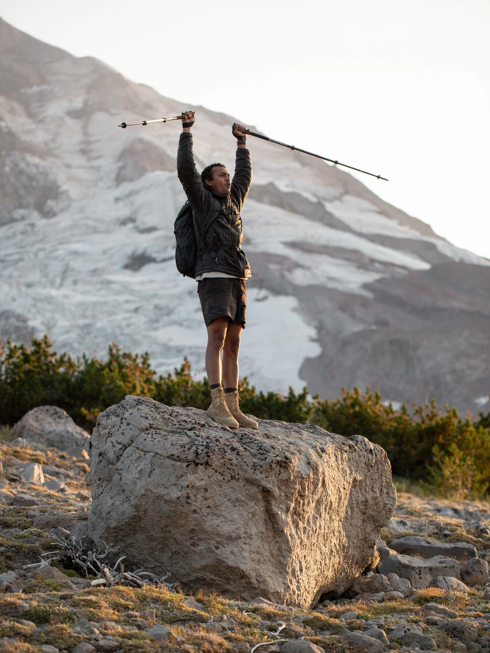 portrait of backpacker in alpine meadow at sunset