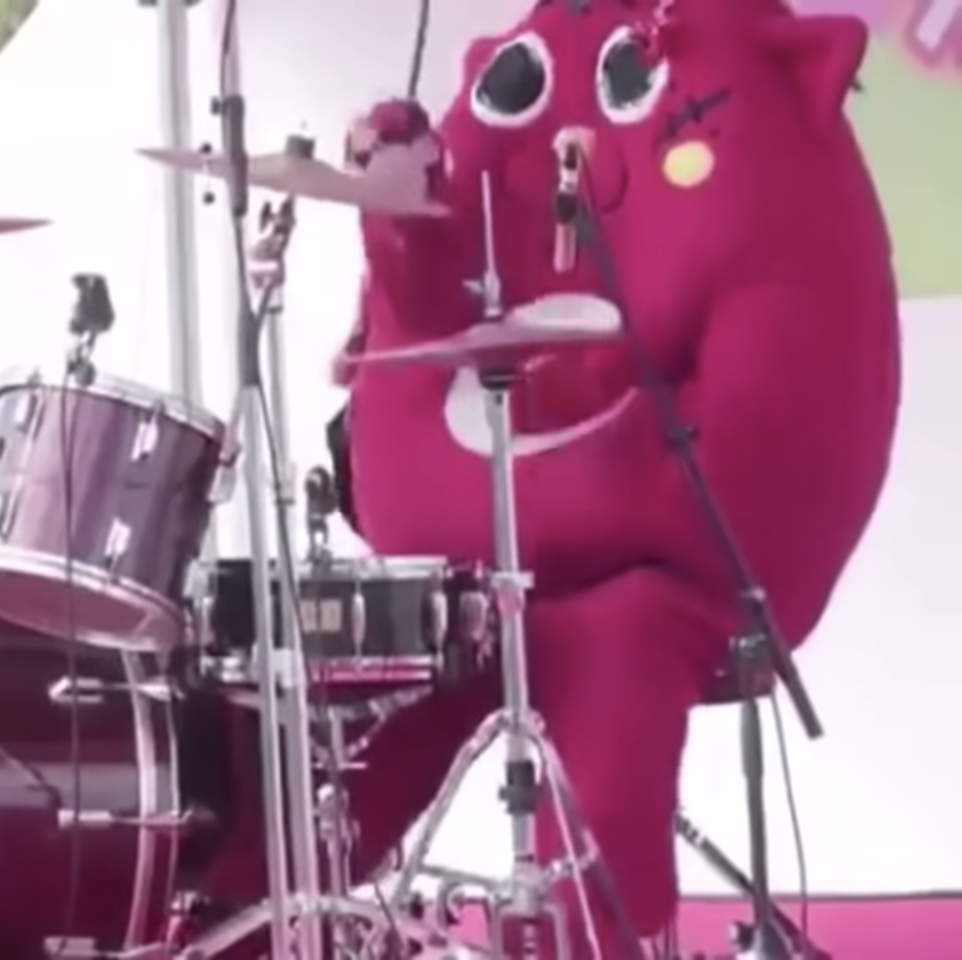 Costumed Person Shreds on Drums
