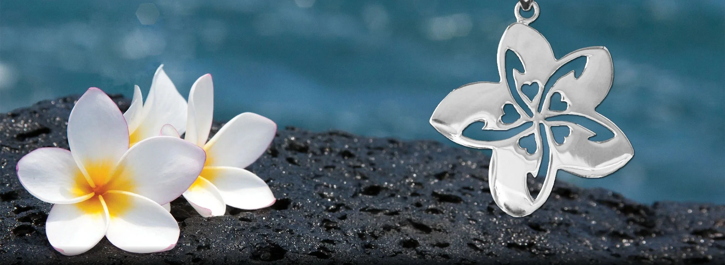 Sterling Silver Plumeria Necklace on lava rocks