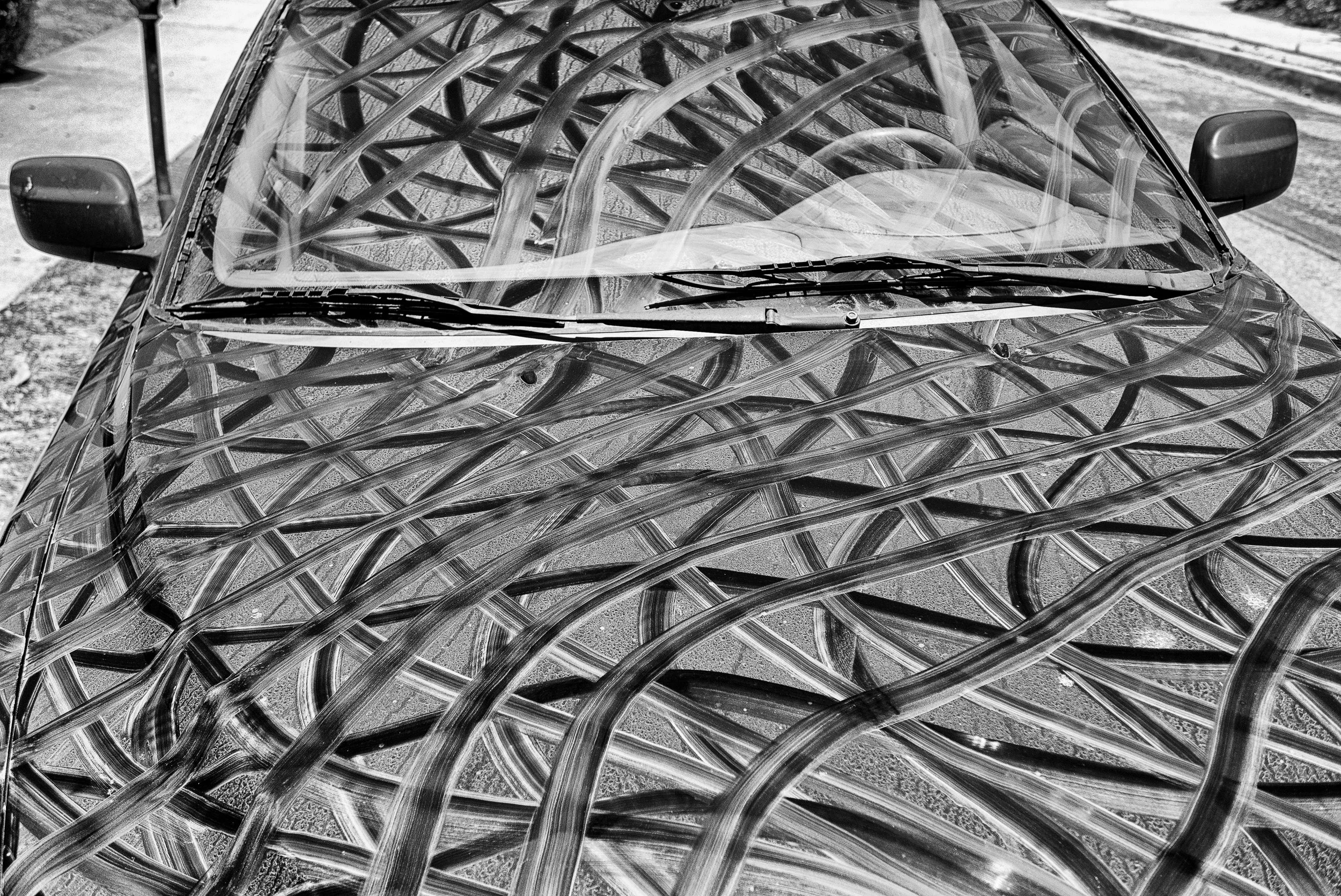  Oscar’s Car Grid, drawn on actual car with water and tinge of watercolor   The grid is a visual metaphor for the fact that we are all connected. As a net thrown into the ocean, it will gather all that cannot pass through it’s open spaces.     My int