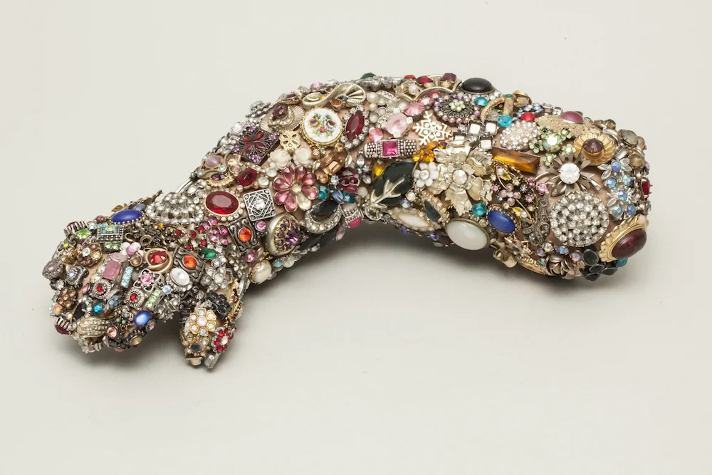 Embellished Baby Mannequin Arm, 2015, mixed media sculpture with encaustic, 3 x 10 x 4 inches