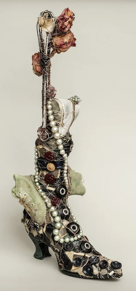 Boot with Baby Shoes, Flowers and Whisk, 2014, mixed media sculpture with encaustic, 20.5 x 6.25 x 10.5 inches