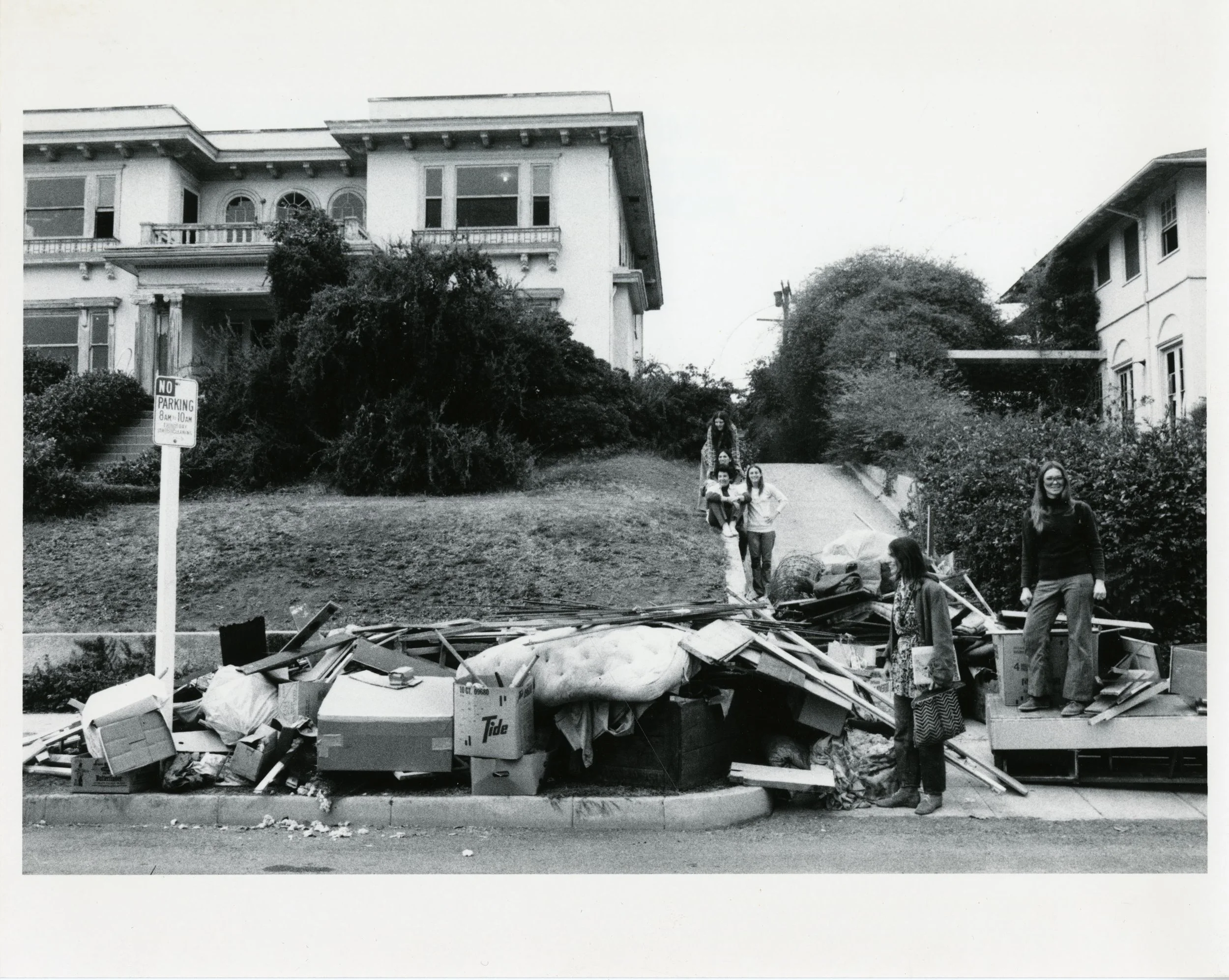 Exterior of Womanhouse, work began on the house in the fall of 1971, photographer unknown, top to bottom: Janice Lester, Robin Schiff, Miriam Schapiro, Susan Fraser, standing in front: Christine Rush, unknown person on the right. From the archives of Miriam Schapiro, used with permission from Rutgers University, New Jersey