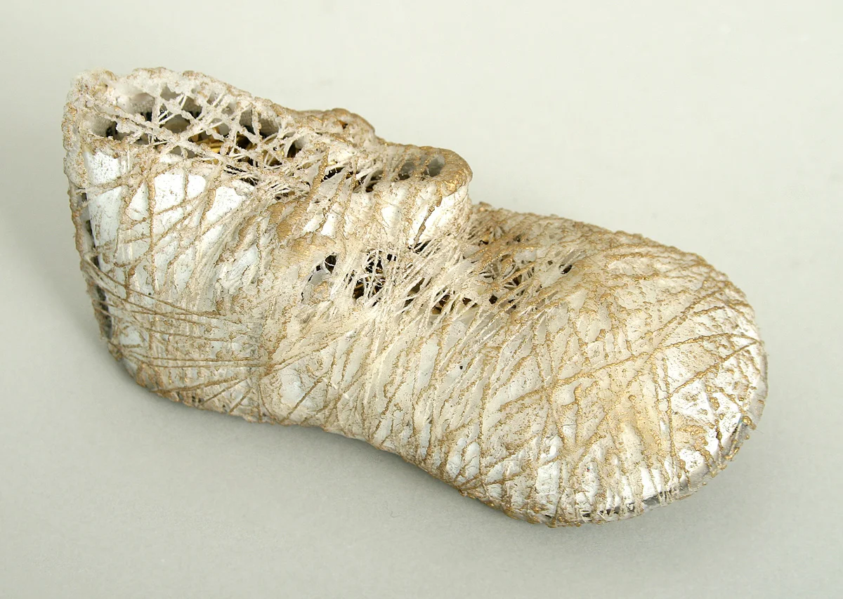 Wrapped Baby #1, 2009, mixed media sculpture with encaustic, 2 x 5 x 2 inches