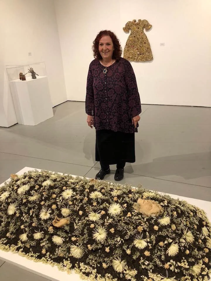 November 10, 2018. The artist next to her installation with drying flowers.  