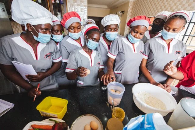  Jazza Centre trainees learning professional domestic home management skills in Nairobi, Kenya. Jazza Centre is on track to train and place 1,000 domestic workers in stable home management positions throughout Kenya in 2021. These positions offer up to a 50% pay increase over the industry average, national health and social security benefits, and training that extends the length of placement and improves self-confidence.  