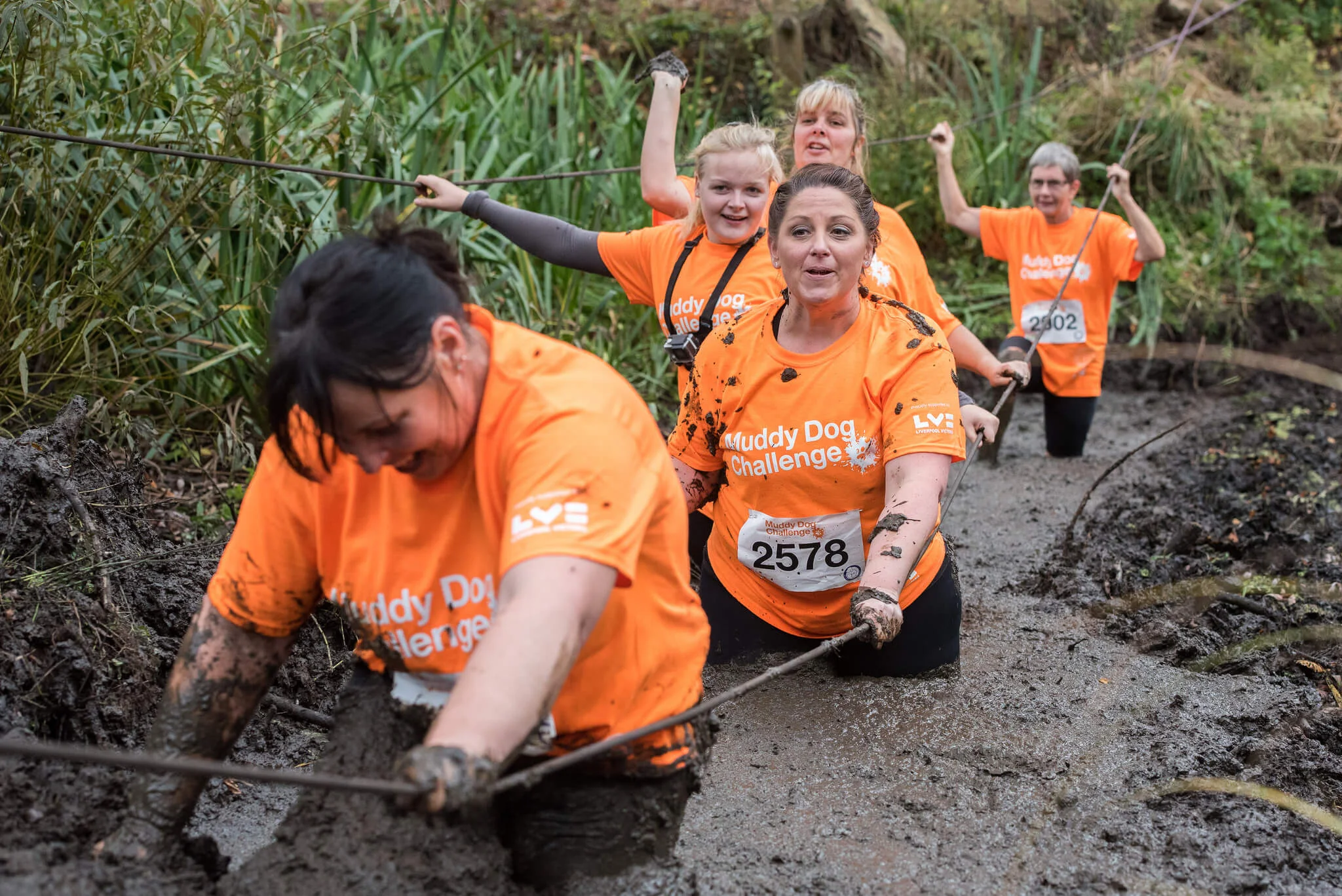Enjoying the mud at the Muddy Dog Challenge