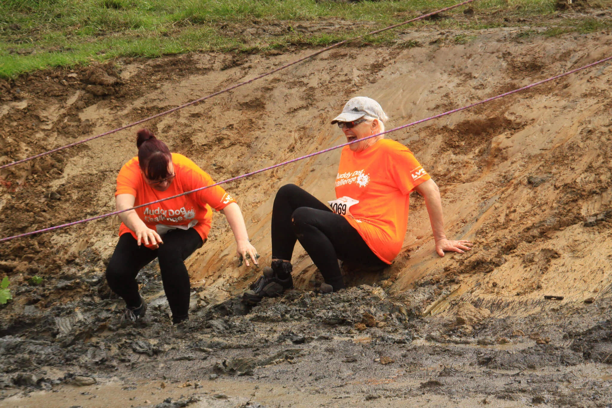 Mud slide at the Muddy Dog Challenge