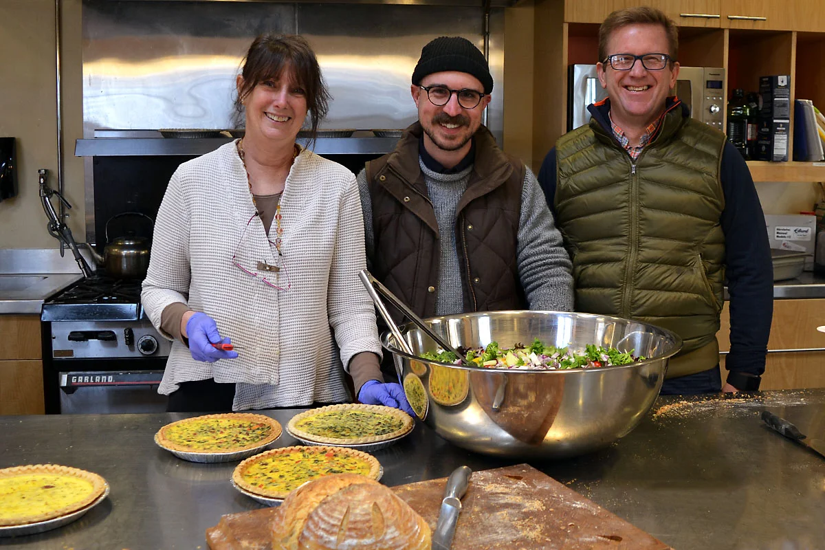 MD365 Executive Director Kathy Miller, Communications Manager Alex Birdsall, and Board member Rodney Eason helped with kitchen prep in anticipation of the large crowd of about 140.