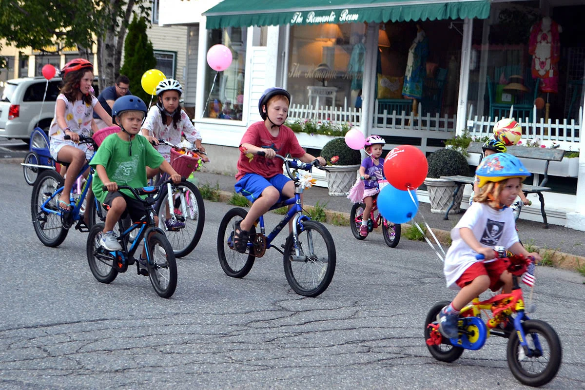 Riders zoom along the parade route for sundaes at the finish line