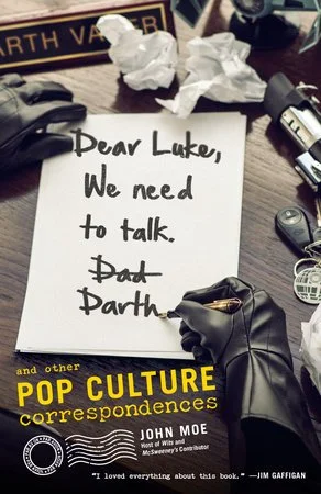A handwritten note on a desk reads, 'Dear Luke, We need to talk. Dad.' surrounded by crumpled paper, a book titled 'Pop Culture,' a pen, and various office supplies.