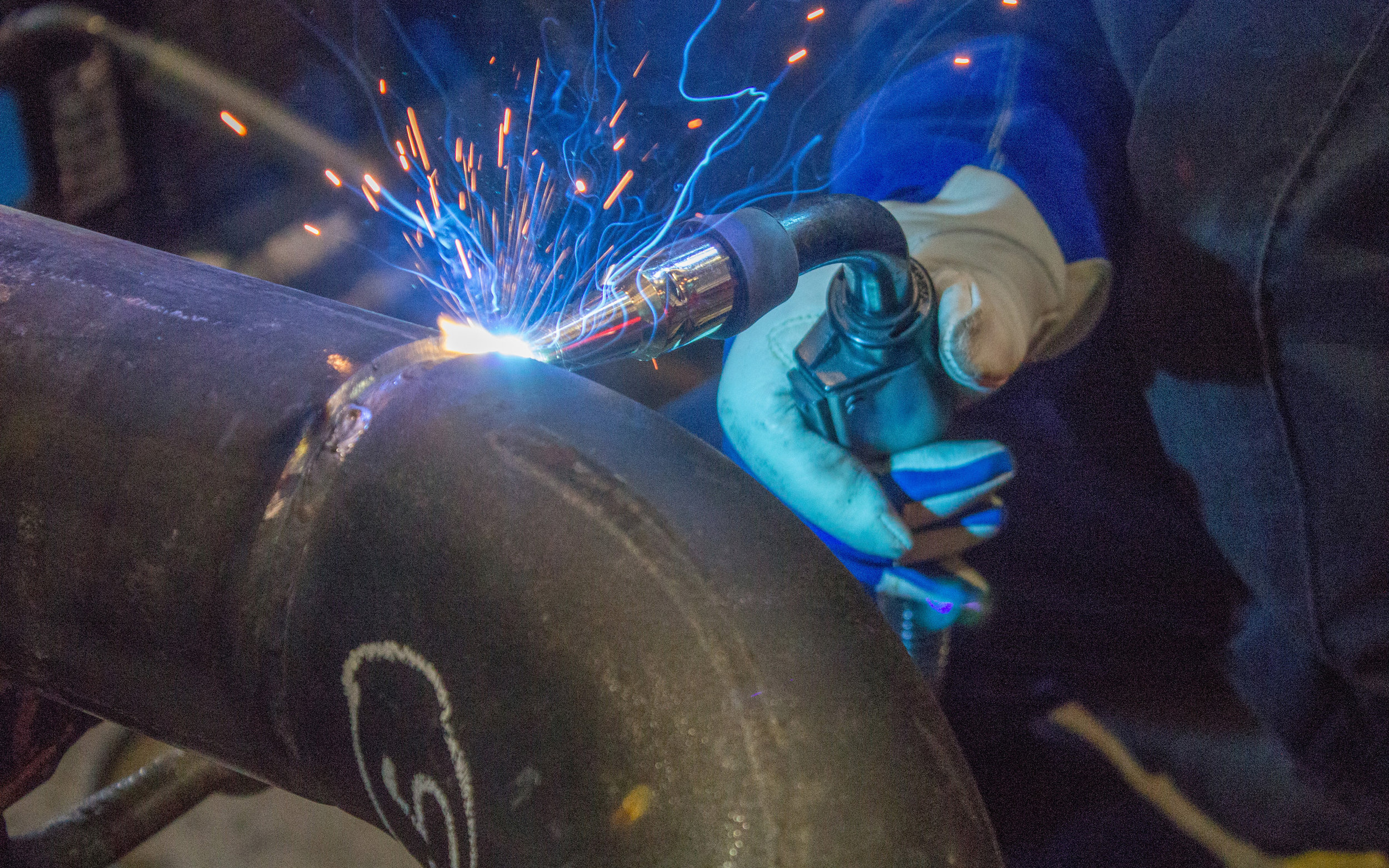 A man welding a pipe